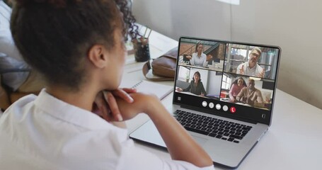 Wall Mural - Animation of biracial woman having video call on laptop