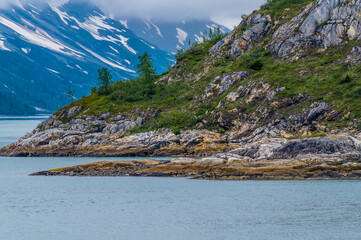 Wall Mural - A view along the rocky shoreline of Glacier Bay, Alaska in summertime