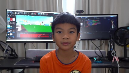 Kid with computer programming and game developing in background, for technology coding concept.