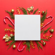 © sosiukin - Flat lay Christmas composition. square Paper blank, pine tree branches, christmas decorations on Colored background. Top view, copy space for text