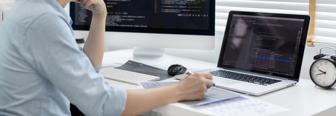 professional development programmers are laying out a structure or draft on paper in preparation for