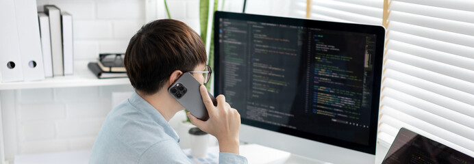 Professional development programmers are talking on the phone with their colleagues for website planning or programming on computers, Write information or code for website,  HTML, javascript, Software