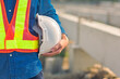 © Suriyo - Engineer holding hard hat construction worker professional safety work industry building person manager service