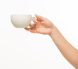 © serhii - female hands hold a white cup on a white background isolated