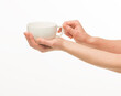 © serhii - female hands hold a white cup on a white background isolated