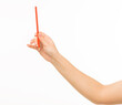© serhii - female hands holding orange pencil on white background isolated