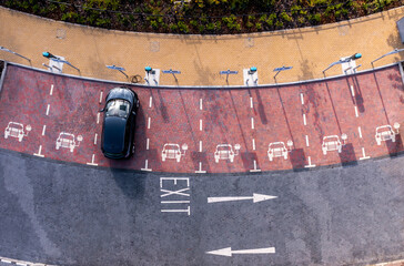 Wall Mural - Aerial view directly above electric car charging facilities