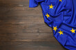 Flag of European Union on wooden background, top view. Space for text
