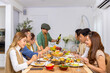 © CandyRetriever  - Group of Asian man and woman friends having dinner with drinking wine and talking together on dining table at home. Happy people friendship enjoy reunion meeting celebration party on holiday vacation