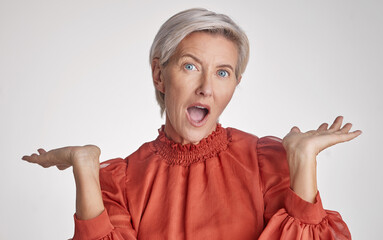 Sticker - Mature surprised, wow and shocked woman face against a grey copy space grey studio background posing with her hands up and feeling unsure. Portrait of senior model making facial expression or emotion