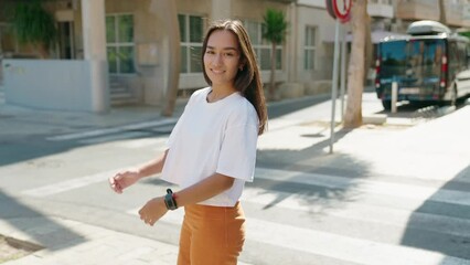 Canvas Print - Young beautiful hispanic woman standing with arms crossed gesture at street