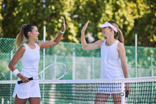 Tennis Match Winner And Fit Female Athlete High Five Hands To Success, Celebrating After Game On Outdoor Sports Court. Women Training Exercise For Wellness, Healthy Fitness Lifestyle And Summer Fun.