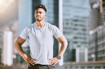 Canvas Print - Athlete man fitness training in city sunrise, doing sports morning run and wellness lifestyle workout. Handsome runner jogging daily, exercise routine and quiet architectural cityscape background.