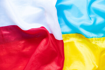 Wall Mural - The flag of Poland and the flag of Ukraine as a background, an alliance between the two countries during the war in Ukraine 2022