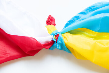 Wall Mural - The flag of Poland and the flag of Ukraine are knotted on a white background, an alliance between the two countries during the war in Ukraine 2022