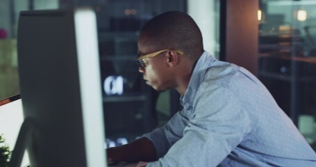Working, typing and writing business man on a office computer online multitasking at night. Digital internet tech developer reading a funny email at work busy with iot, web and blockchain research