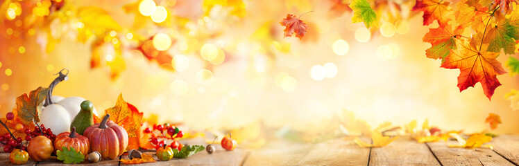 Wall Mural - autumn banner with fallen maple leaves and pumpkins on wooden vintage table. autumn concept with red
