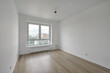 Empty room after repairs in an apartment building. Standard, stereotype fresh renovated room with wooden floor