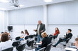 © Anna Kosolapova - A gray-haired professor of mathematics in college teaches classes in higher mathematics, he walks between the rows of students in the audience and answers their questions