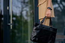Business Lady Holding A Laptop Bag Going To The Office. Display Of Businesswoman On Modern Buildings In The City