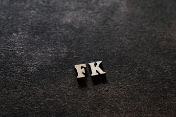 Wall Mural - the letters f and k above the dark field. initials fk