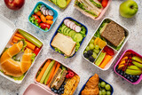 Fototapeta Kawa jest smaczna - Shot of school lunchboxes with various healthy nutritious meals on stone background