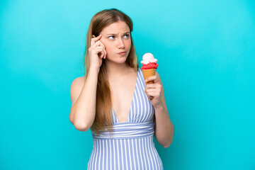 Wall Mural - Young caucasian woman in swimsuit eating ice cream isolated on blue background having doubts and with confuse face expression