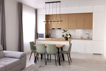 Scandinavian style cozy modern white kitchen interior with a dining zone, white modern interior in farmhouse style. nordic living roomin loft apartment. 3D rendering. High quality photo.