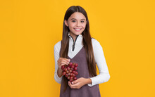 Happy Child Hold Healthy Grapes Fruit On Yellow Background