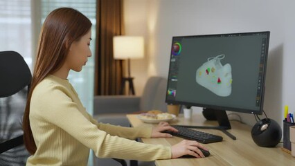 Asian Female Freelancer Working with Inspiration in her Studio. Young female designer using 3d program to design her product. 