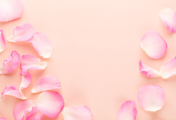 Wall Mural - Rose flowers petals on pastel background. Valentines day background. Flat lay, top view, copy space.