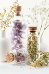 Wall Mural - Dried herbal flowers with bottle. Homeopathy background.