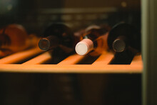 Wine Bottles In Wooden Rack In Wine Cellar.
