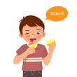 cute little boy holding lemon showing sour taste of tongue five senses
