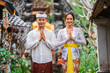 © Odua Images - happy beautiful balinese couple greeting and smiling gesture at camera