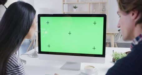 Wall Mural - Green screen, mockup or chroma key on computer and digital technology with tracking markers for marketing, advertising or promotion. Business team working on graphic design in a startup tech company