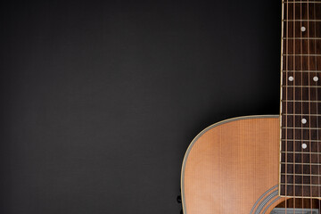 Wall Mural - close up acoustic guitar on black table background, music concept