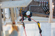 © chitsanupong - Top view male worker inspection wearing safety first harness rope safety line working at a high place on tank roof spherical