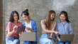 © amnaj - Happy group of young Asian women sitting together using laptop computer.