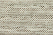 A fragment of a woven rug made of threads, as a background or texture, close-up.