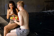 Young couple enjoying in indoor swimming pool on vacation