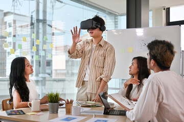 Diverse development team testing virtual reality headset, brainstorming on augmented reality improvement, future technology.