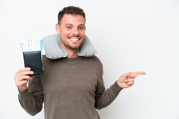 Wall Mural - Young caucasian man holding a passport isolated on white background pointing finger to the side