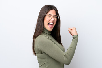 Young Brazilian woman isolated on white background celebrating a victory