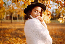Stylish Woman Enjoying Autumn Weather In The Park. Fashion, Style Concept.