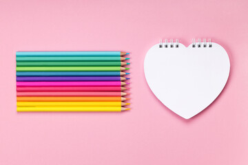 Pastel colored pencils white heart-shaped notepad