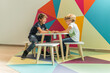 © ADDICTIVE STOCK - Kids sitting at table in clinic playroom