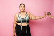 Beautiful plus size woman in activewear dieting determined to lose weight