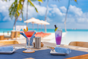 Closeup morning table food palm trees, infinity pool cocktails in luxury resort hotel poolside, outdoor restaurant beach, ocean and sky, tropical island cafe. Summer vacation or holiday, family travel