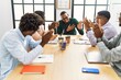 © Krakenimages.com - Group of african american business workers smiling and clapping to partner at the office.